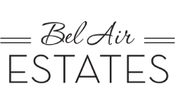 A logo with the word "Bel Air Estates" written in a stylized font.
